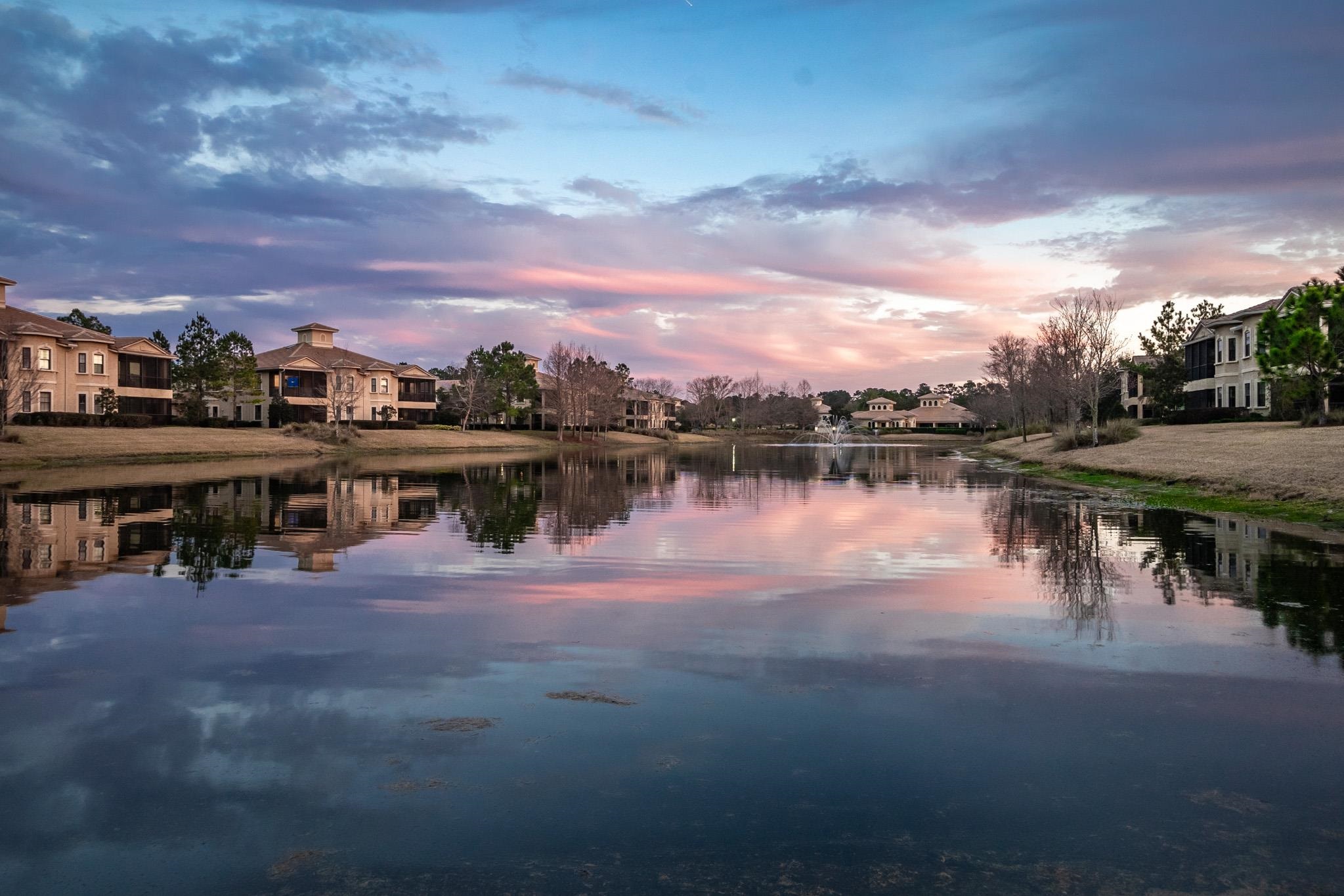 131 Laterra Links Circle, Unit 101 St. Augustine, FL 32092 - Photo 3 of 60 a view of a lake with houses in the back