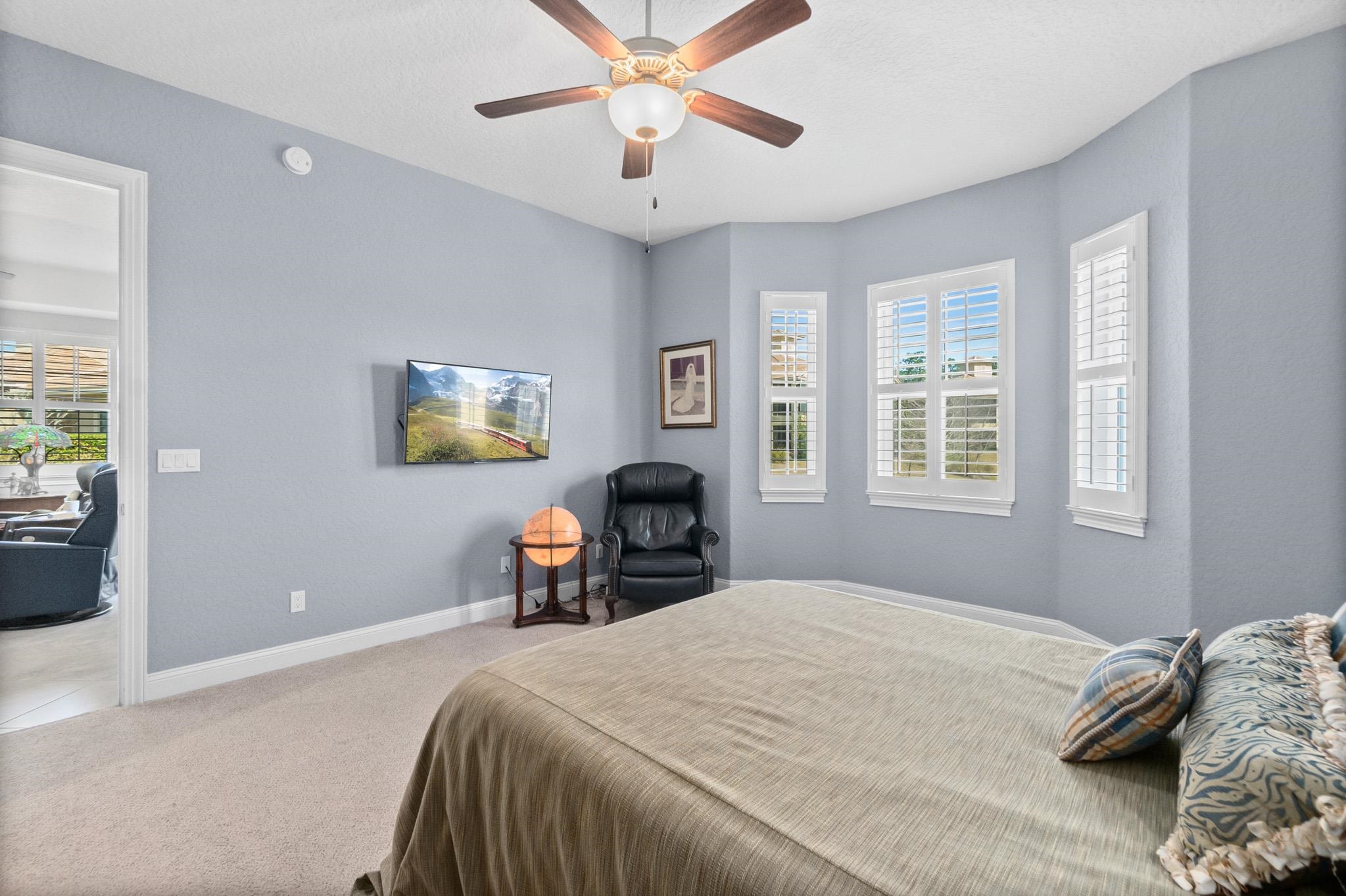 131 Laterra Links Circle, Unit 101 St. Augustine, FL 32092 - Photo 32 of 60 a bedroom with a bed and a chandelier