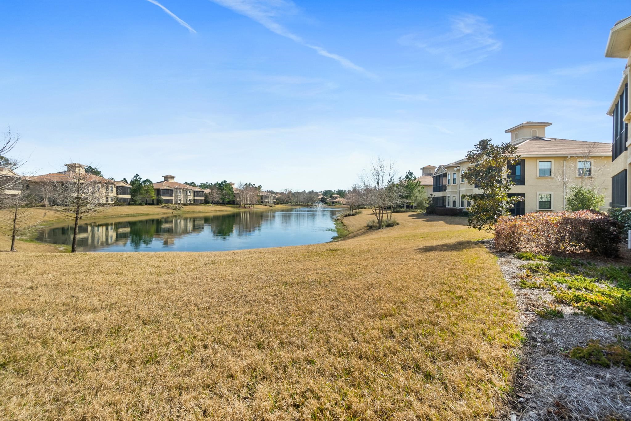 131 Laterra Links Circle, Unit 101 St. Augustine, FL 32092 - Photo 43 of 60 a view of a lake with houses