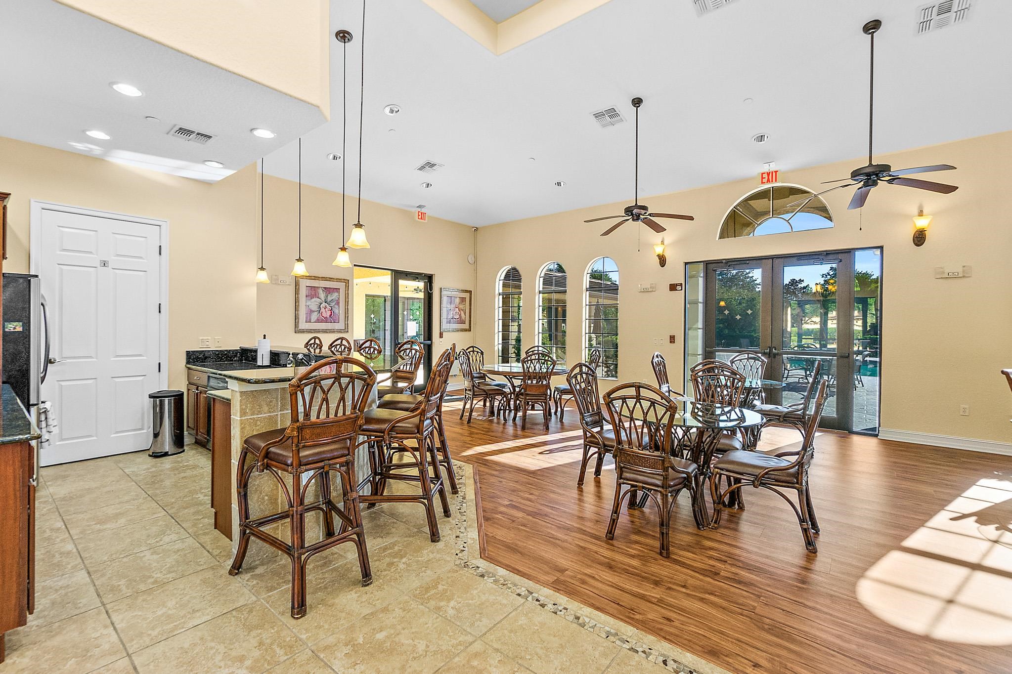 131 Laterra Links Circle, Unit 101 St. Augustine, FL 32092 - Photo 54 of 60 a view of a dining room and livingroom with furniture wooden floor a chandelier