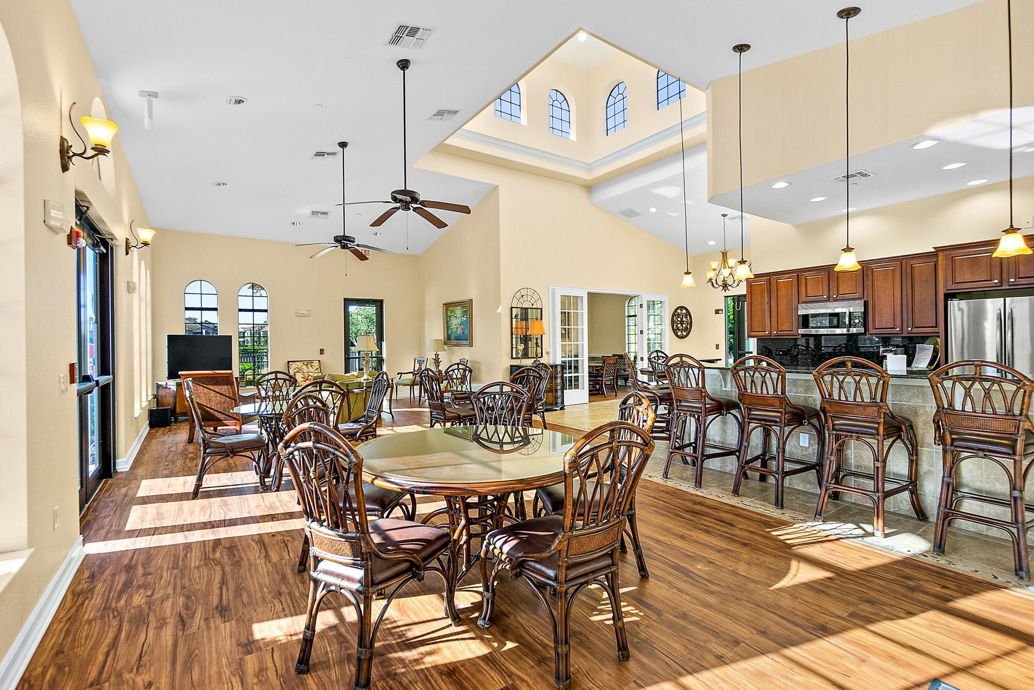 131 Laterra Links Circle, Unit 101 St. Augustine, FL 32092 - Photo 55 of 60 a view of a dining room and livingroom with furniture wooden floor a chandelier