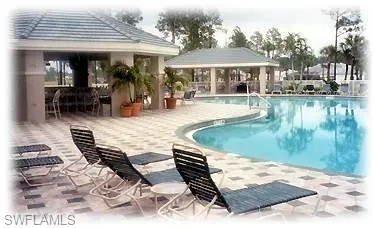 a view of a patio with chairs and umbrellas on a patio
