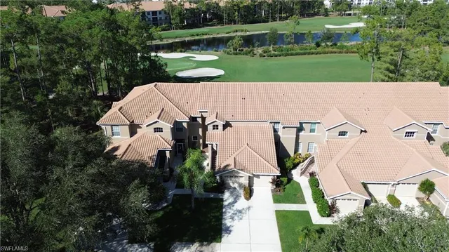 an aerial view of a house with a yard and outdoor seating