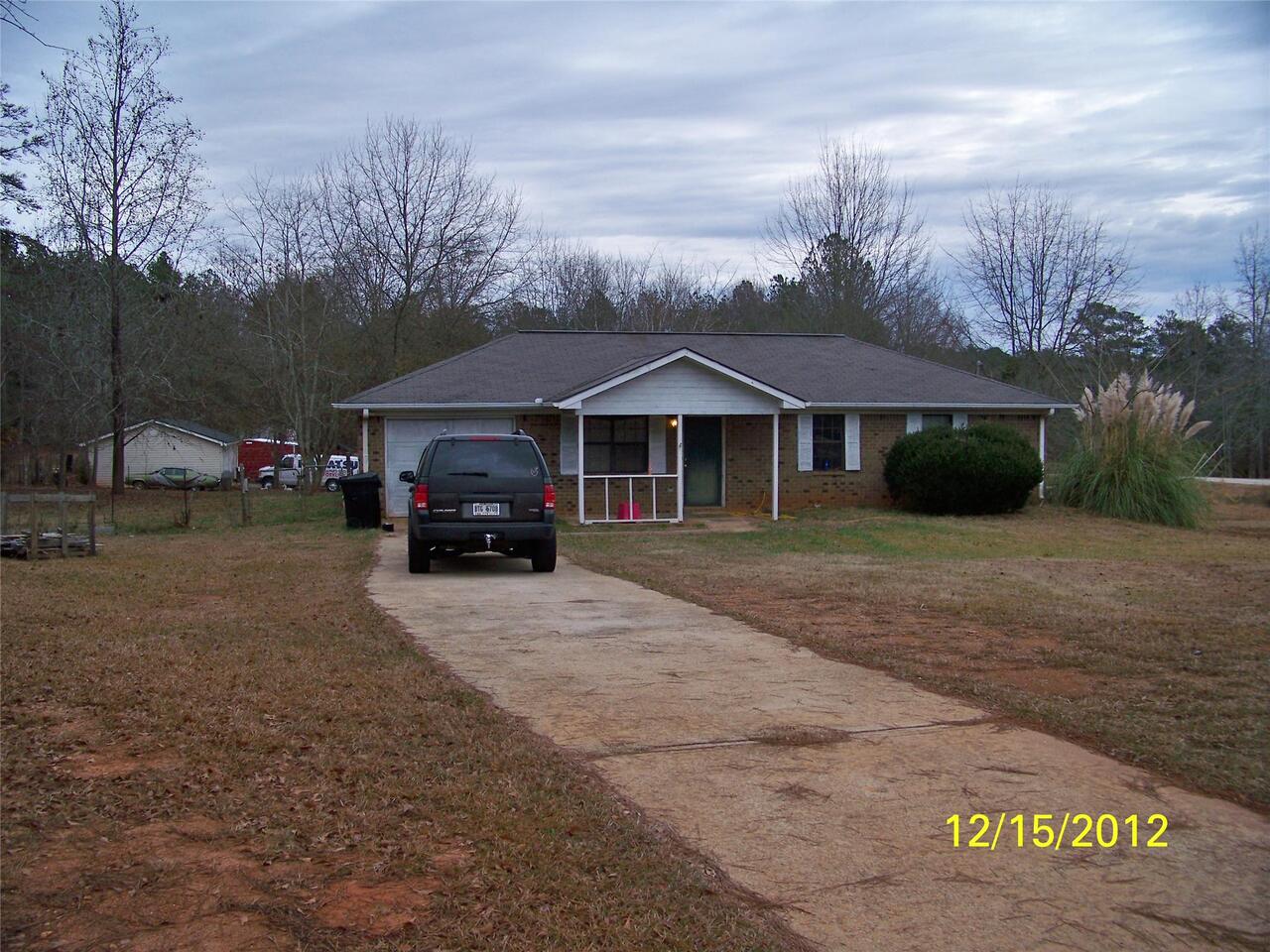 845 Laney Road Locust Grove, GA 30248 - Photo 1 of 1 a car parked in front of house