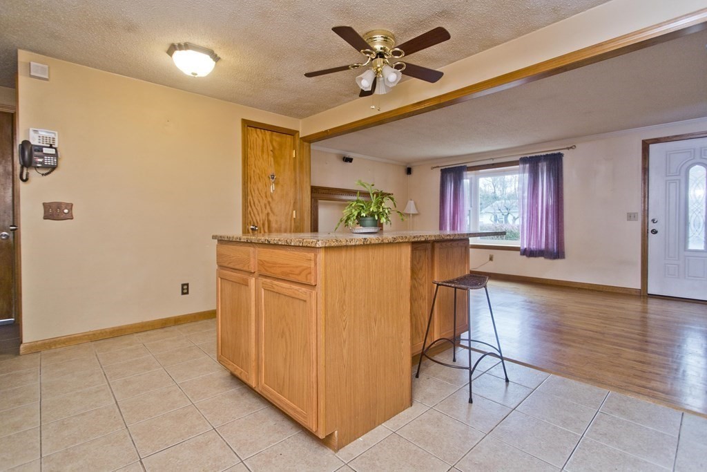 191 Pine Acre Road Springfield, MA 01129 - Photo 5 of 35 a dining hall with stainless steel appliances granite countertop a stove a sink and a refrigerator with wooden floor