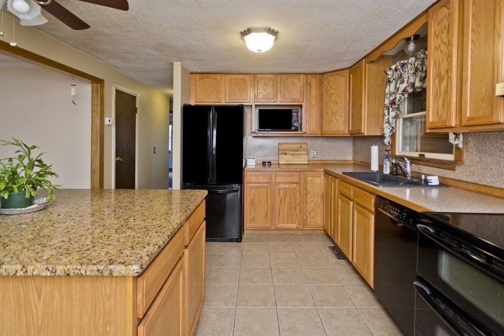 191 Pine Acre Road Springfield, MA 01129 - Photo 7 of 35 a kitchen with stainless steel appliances granite countertop a sink stove and refrigerator