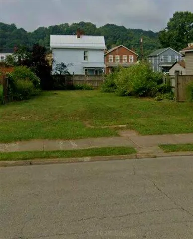 a view of a house with a big yard and potted plants