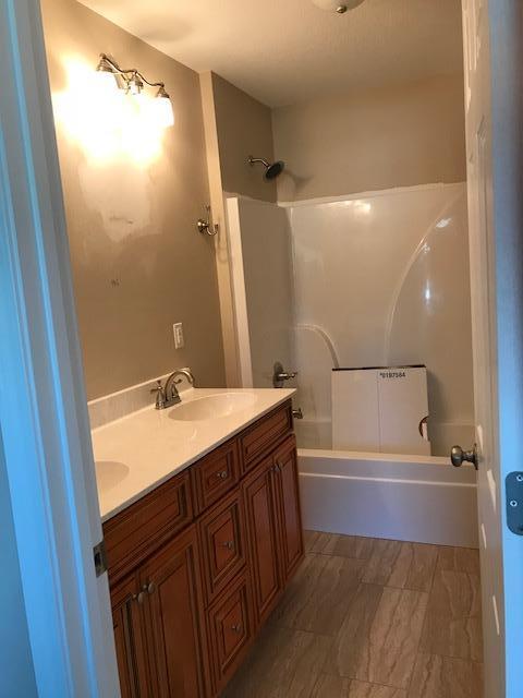 6010 Medfords Way Crestview, FL 32539 - Photo 12 of 15 a bathroom with a sink a mirror and a bathtub