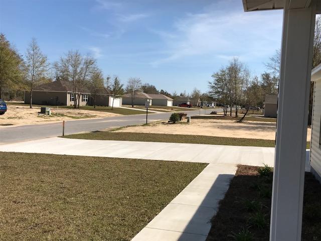 6010 Medfords Way Crestview, FL 32539 - Photo 15 of 15 a view of a swimming pool with an outdoor seating and a yard