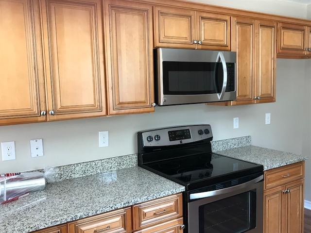 6010 Medfords Way Crestview, FL 32539 - Photo 3 of 15 a kitchen with granite countertop white cabinets stainless steel appliances and a sink