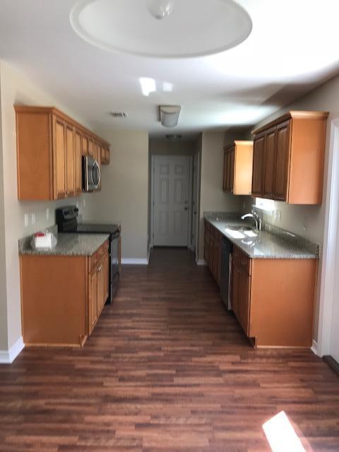 6010 Medfords Way Crestview, FL 32539 - Photo 4 of 15 a kitchen with stainless steel appliances granite countertop a sink and a stove top oven