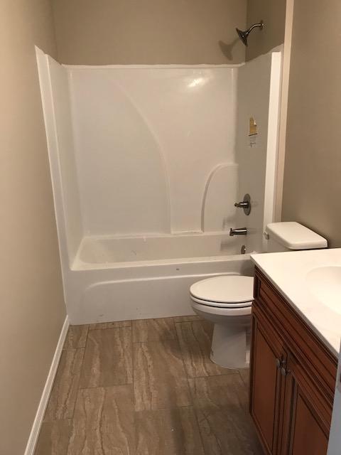 6010 Medfords Way Crestview, FL 32539 - Photo 7 of 15 a bathroom with a granite countertop toilet a sink and bathtub