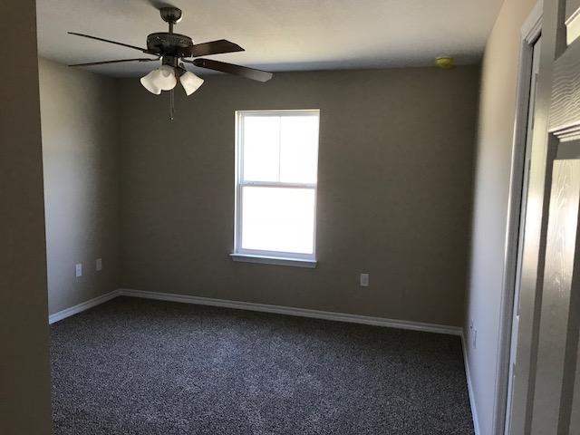 6010 Medfords Way Crestview, FL 32539 - Photo 9 of 15 an empty room with a window and a fan