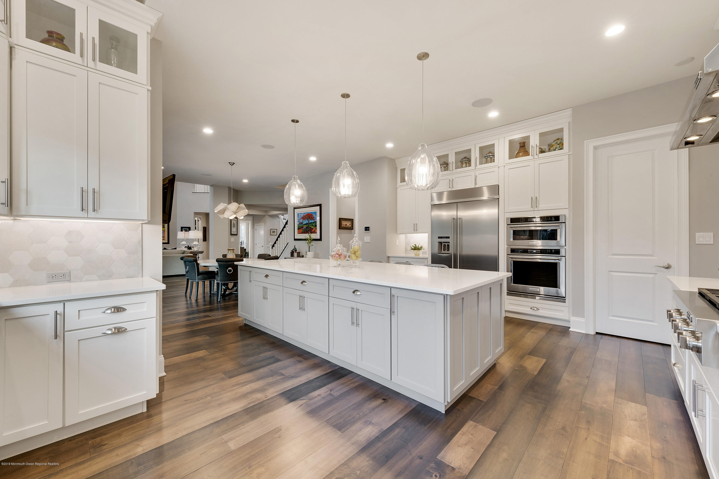 42 Windermere Road Lincroft, NJ 07738 - Photo 22 of 50 a kitchen with stainless steel appliances kitchen island wooden floors and white cabinets