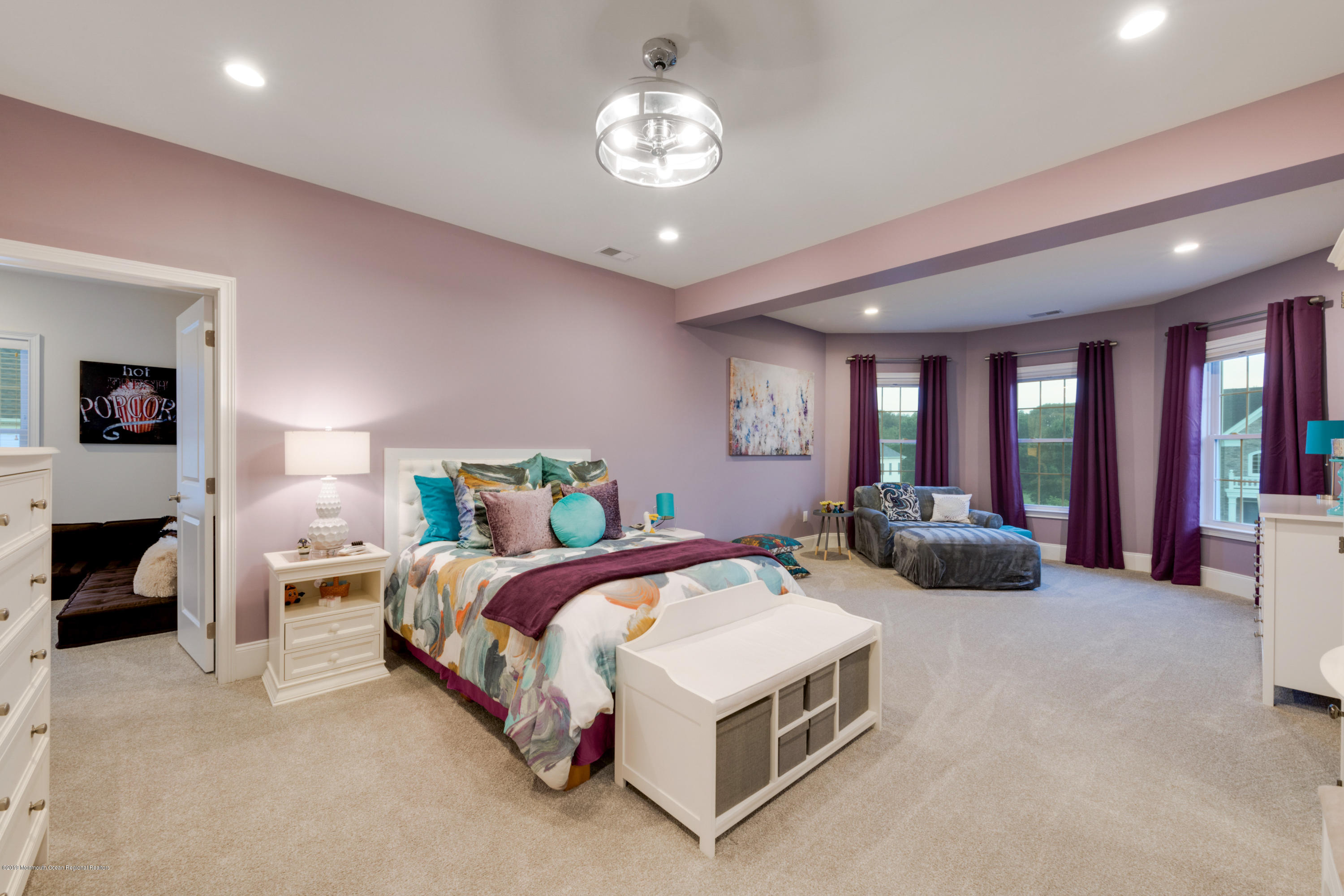 42 Windermere Road Lincroft, NJ 07738 - Photo 37 of 50 a spacious bedroom with a bed mirror and couch