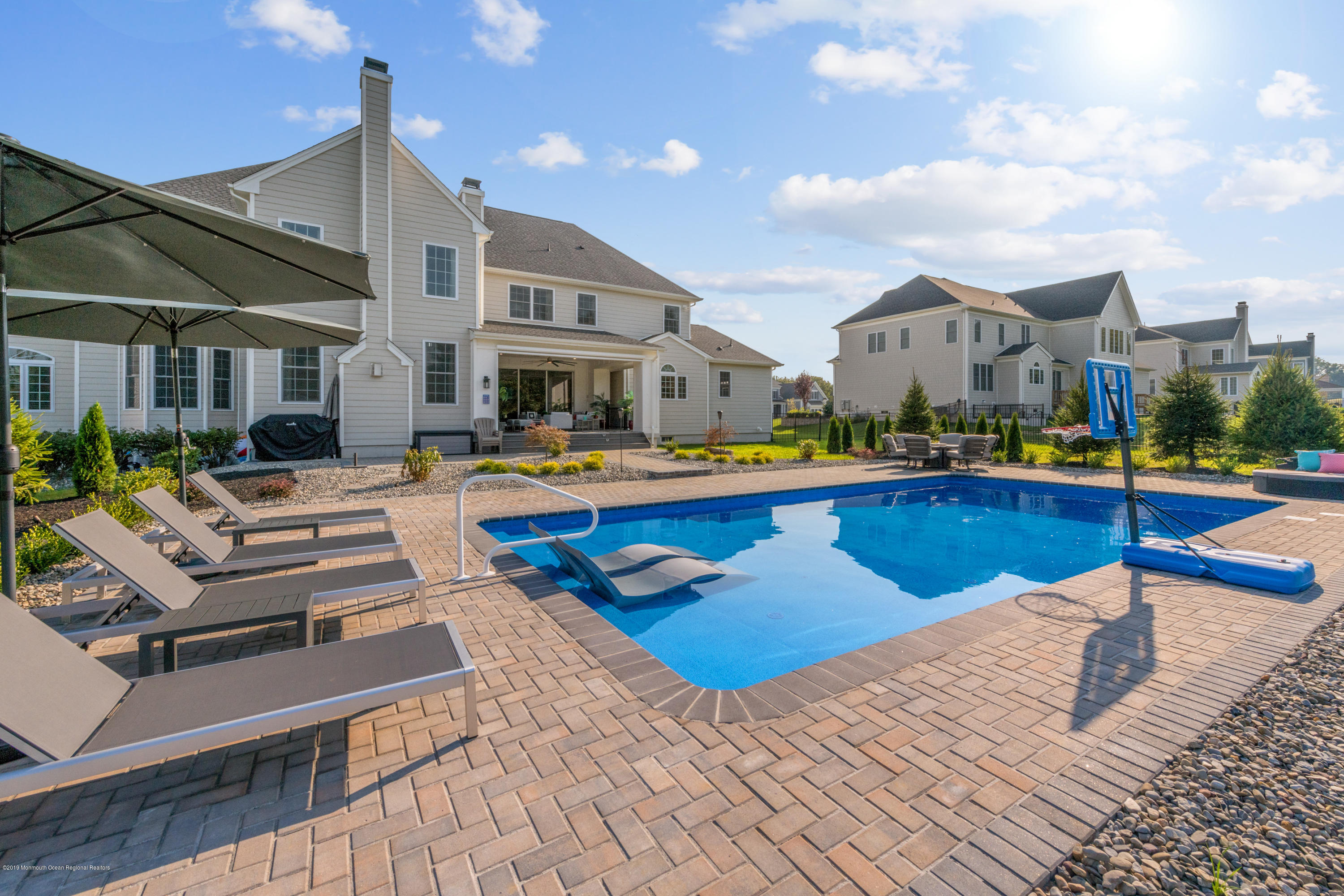 42 Windermere Road Lincroft, NJ 07738 - Photo 42 of 50 a view of a house with swimming pool and sitting area