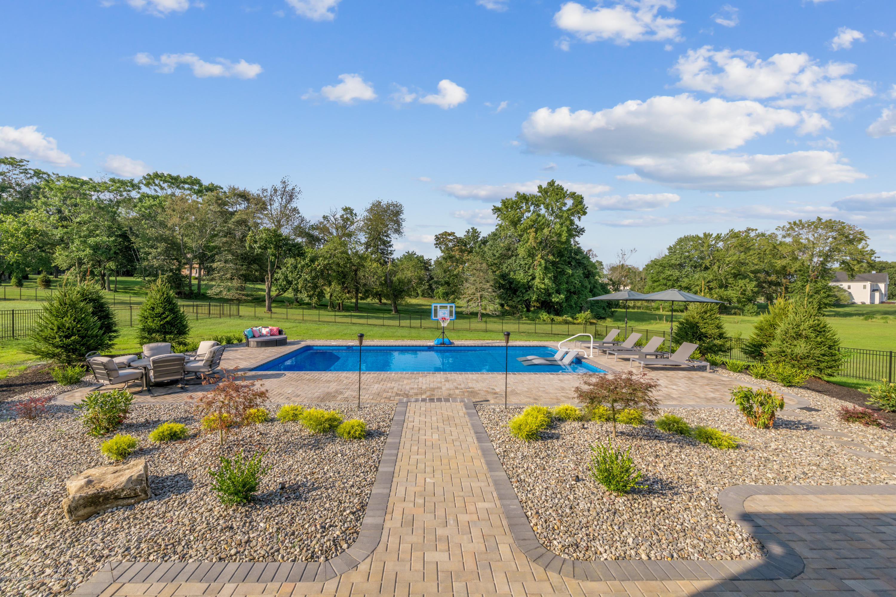 42 Windermere Road Lincroft, NJ 07738 - Photo 43 of 50 a view of swimming pool with lawn chairs and plants