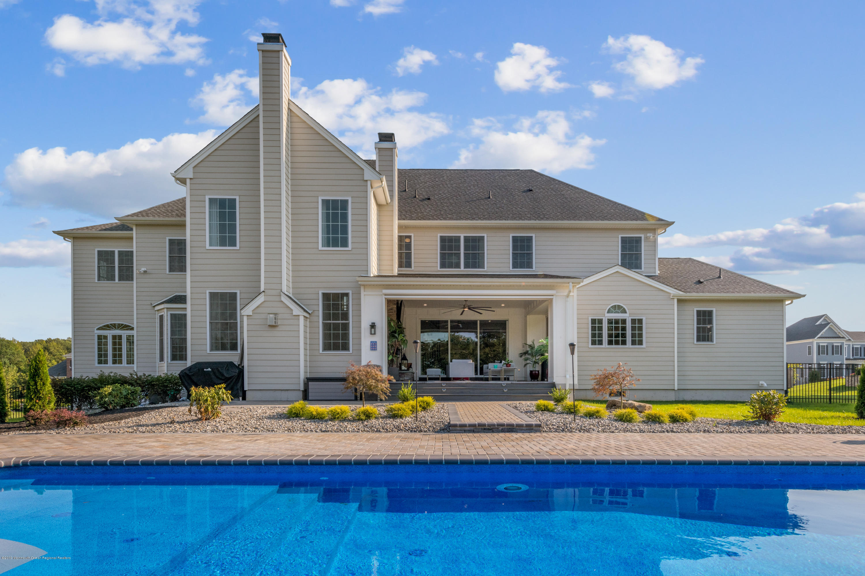 42 Windermere Road Lincroft, NJ 07738 - Photo 44 of 50 a front view of house with yard and swimming pool