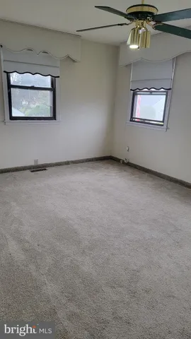 an empty room with a painting on the wall