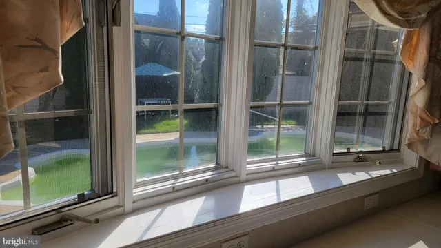 a view of a glass door with a yard from a window