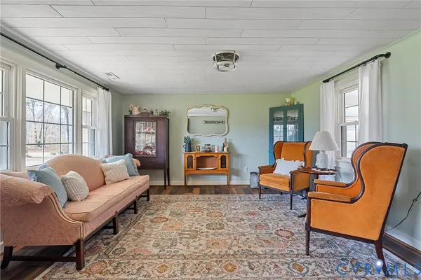 a bed room with a bed and two chairs