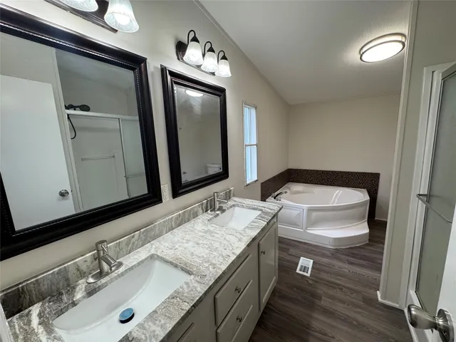 a bathroom with a granite countertop sink and a mirror