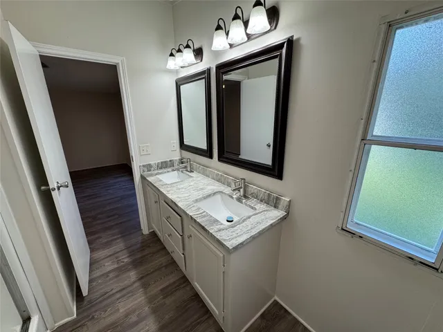 a bathroom with 2 sink and a mirror