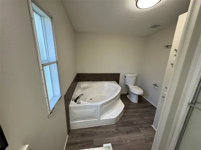 a bathroom with a bathtub and toilet