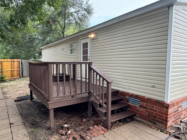 a view of a wooden deck with a back yard