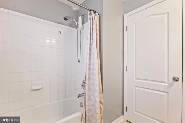 a bathroom with a shower and a tub