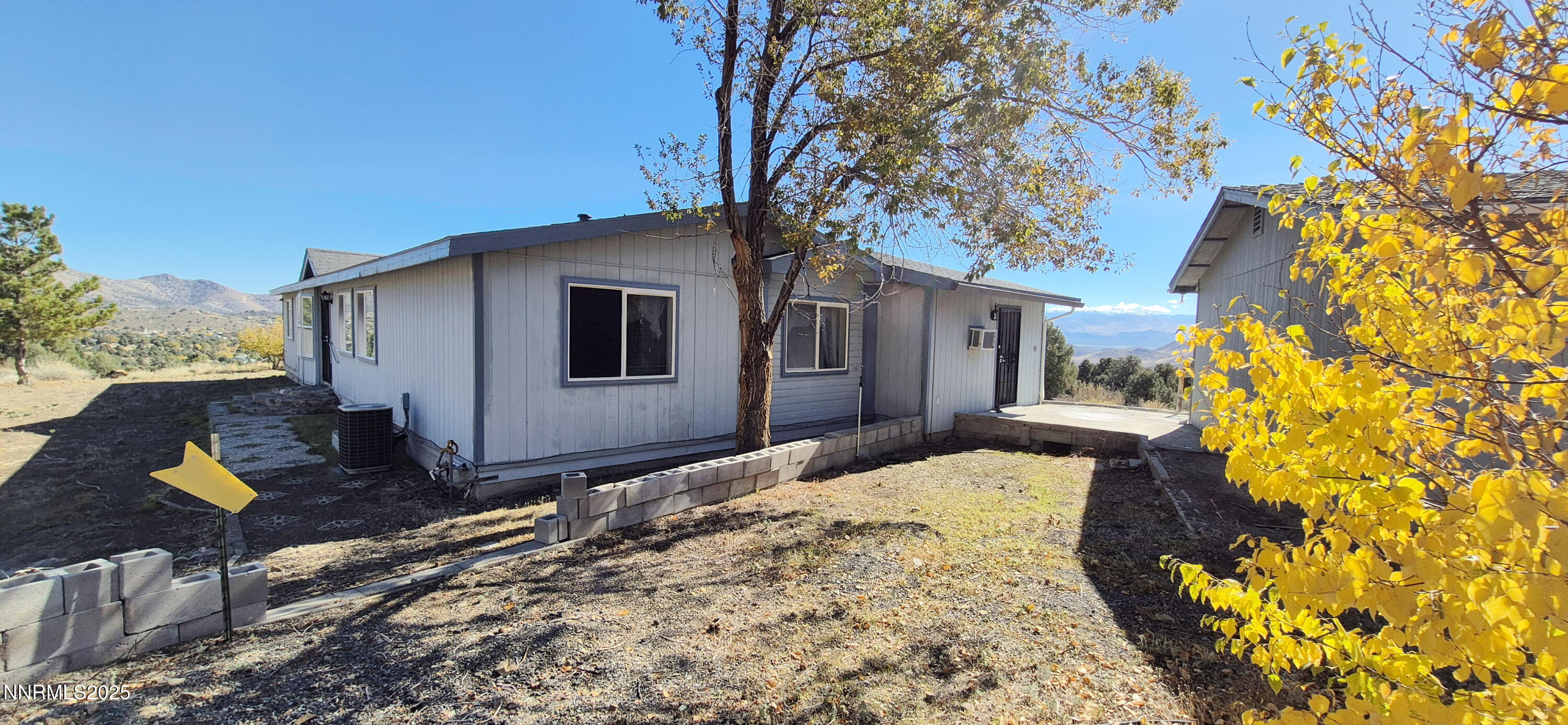 1275 Slate Road Topaz Ranch Estates, NV 89444 - Photo 4 of 6 a backyard of a house with wooden fence and trees