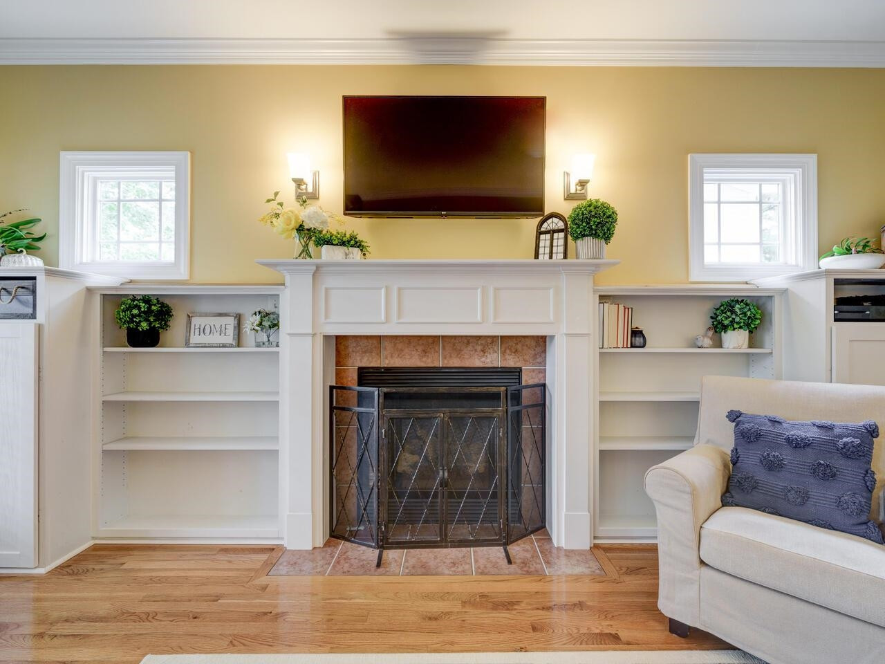 1015 Scotts Ridge Trail Apex, NC 27502 - Photo 5 of 51 Bookcases and built-ins on both sides of the fireplace. The left side is set up as a drop zone with hooks for backpacks and bins below. Doors on both sets of storage next to the bookcases. Family Room