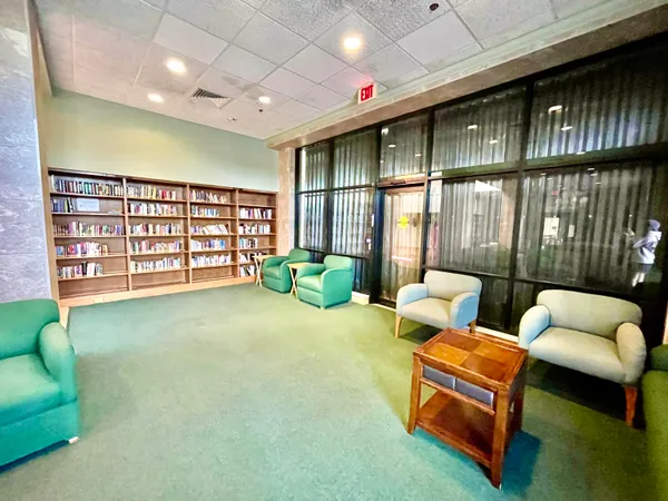 a view of a hallway with closet and bathroom