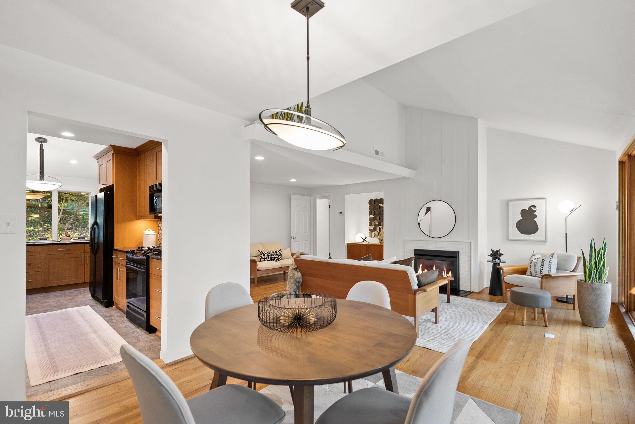 7111 Braeburn Place Bethesda, MD 20817 - Photo 14 of 86 a living room with dining table a couch and a chandelier