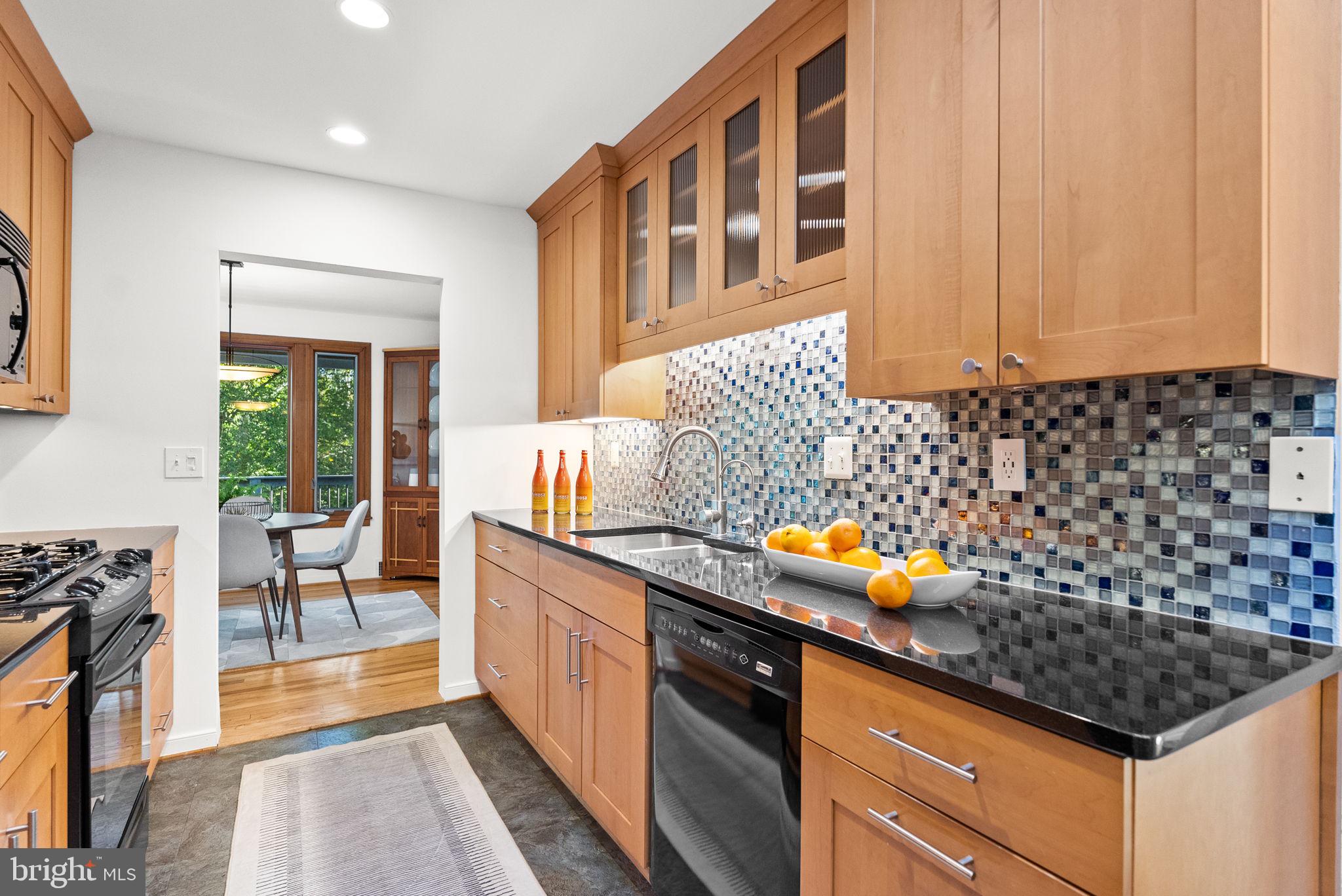 7111 Braeburn Place Bethesda, MD 20817 - Photo 18 of 86 a kitchen with stainless steel appliances a stove a sink and a refrigerator
