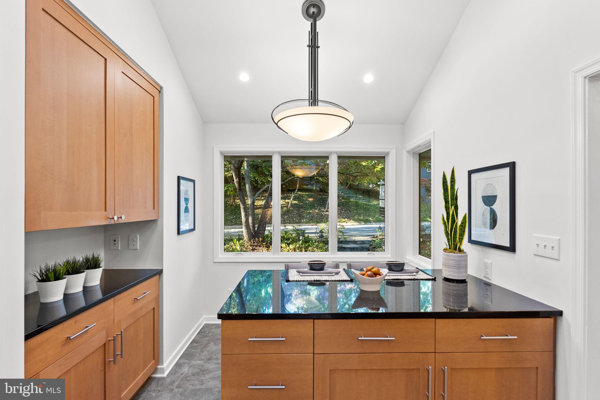 7111 Braeburn Place Bethesda, MD 20817 - Photo 19 of 86 a kitchen with large window and stainless steel appliances
