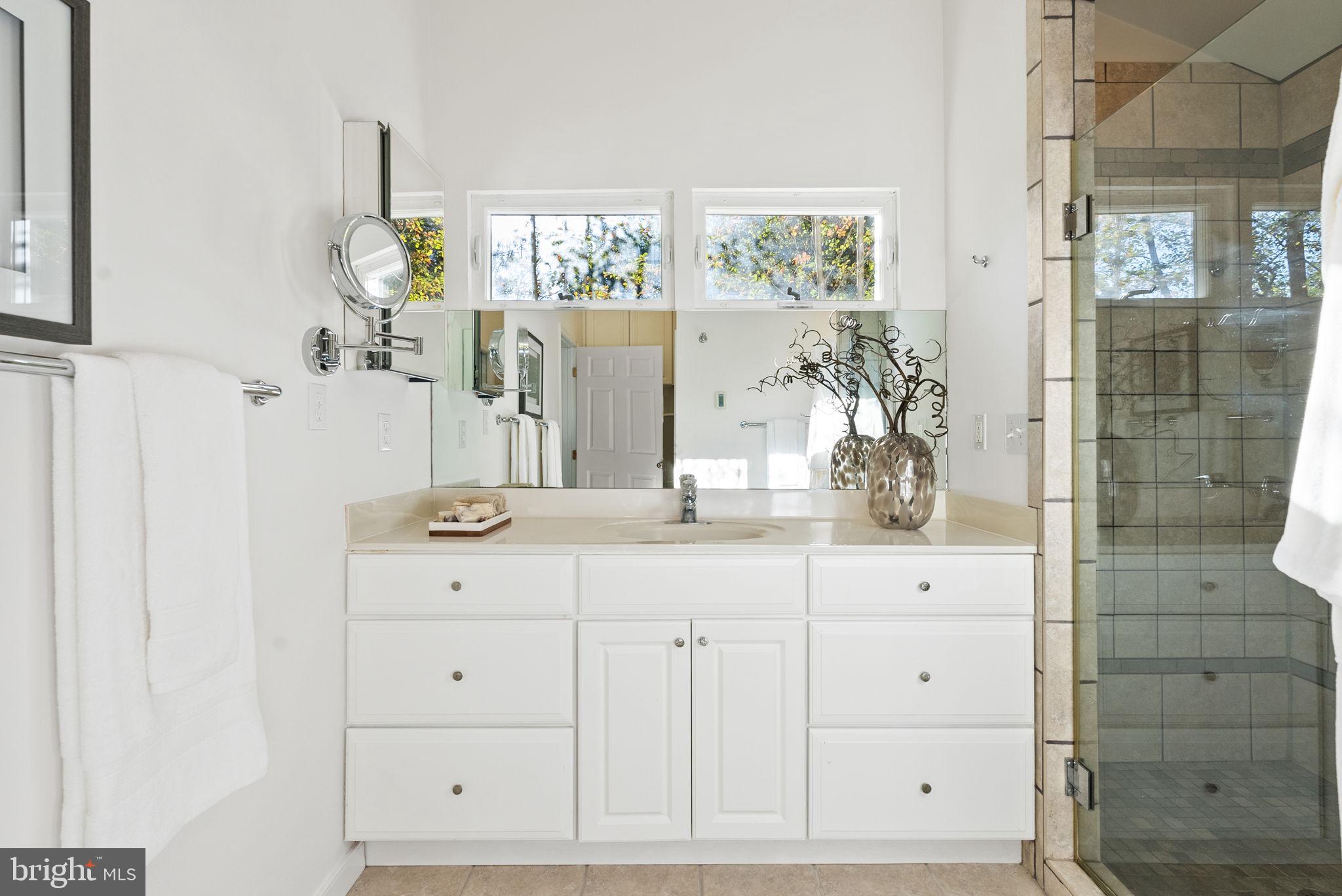 7111 Braeburn Place Bethesda, MD 20817 - Photo 25 of 86 a bathroom with a sink and a mirror
