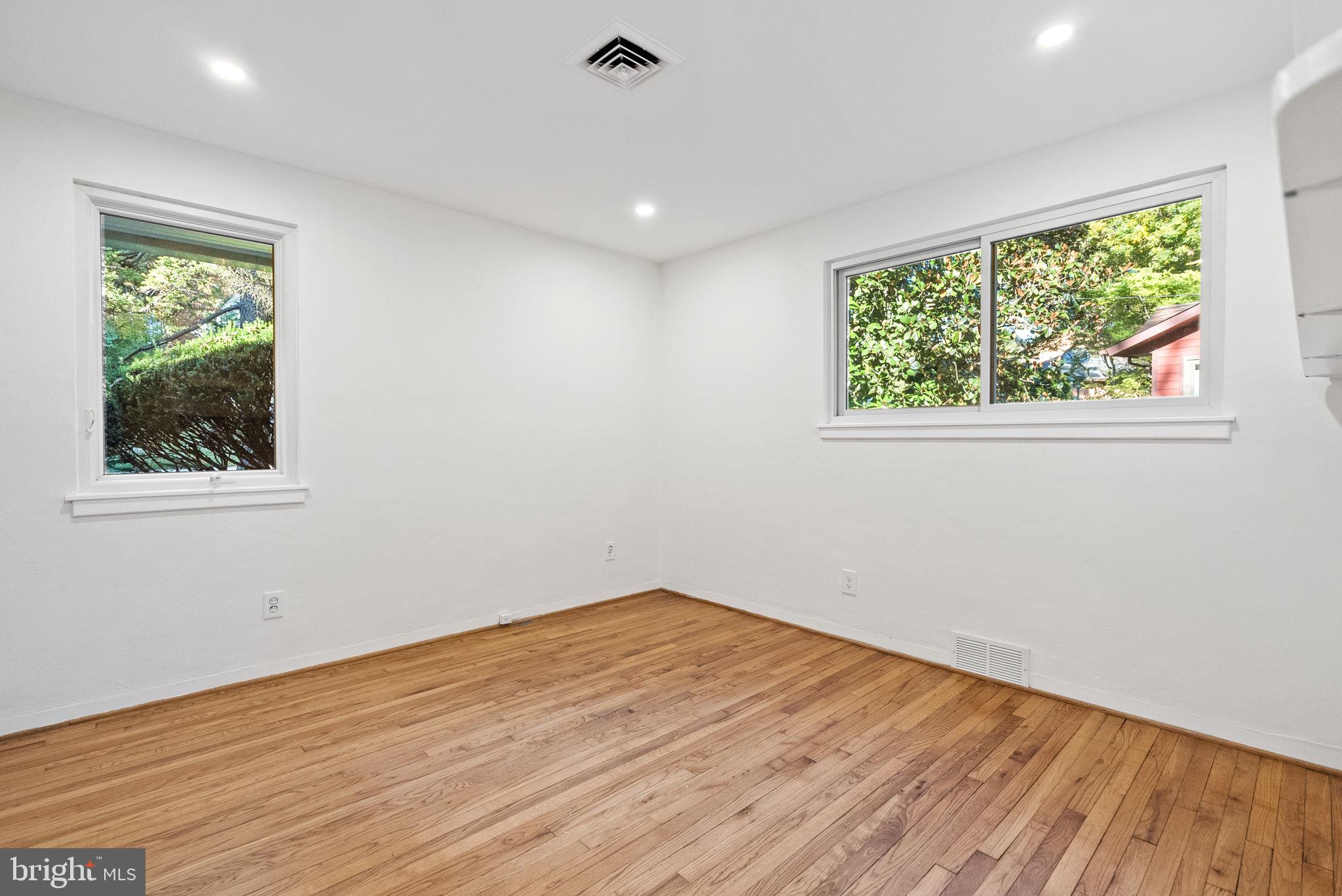 7111 Braeburn Place Bethesda, MD 20817 - Photo 37 of 86 a view of empty room with wooden floor and fan