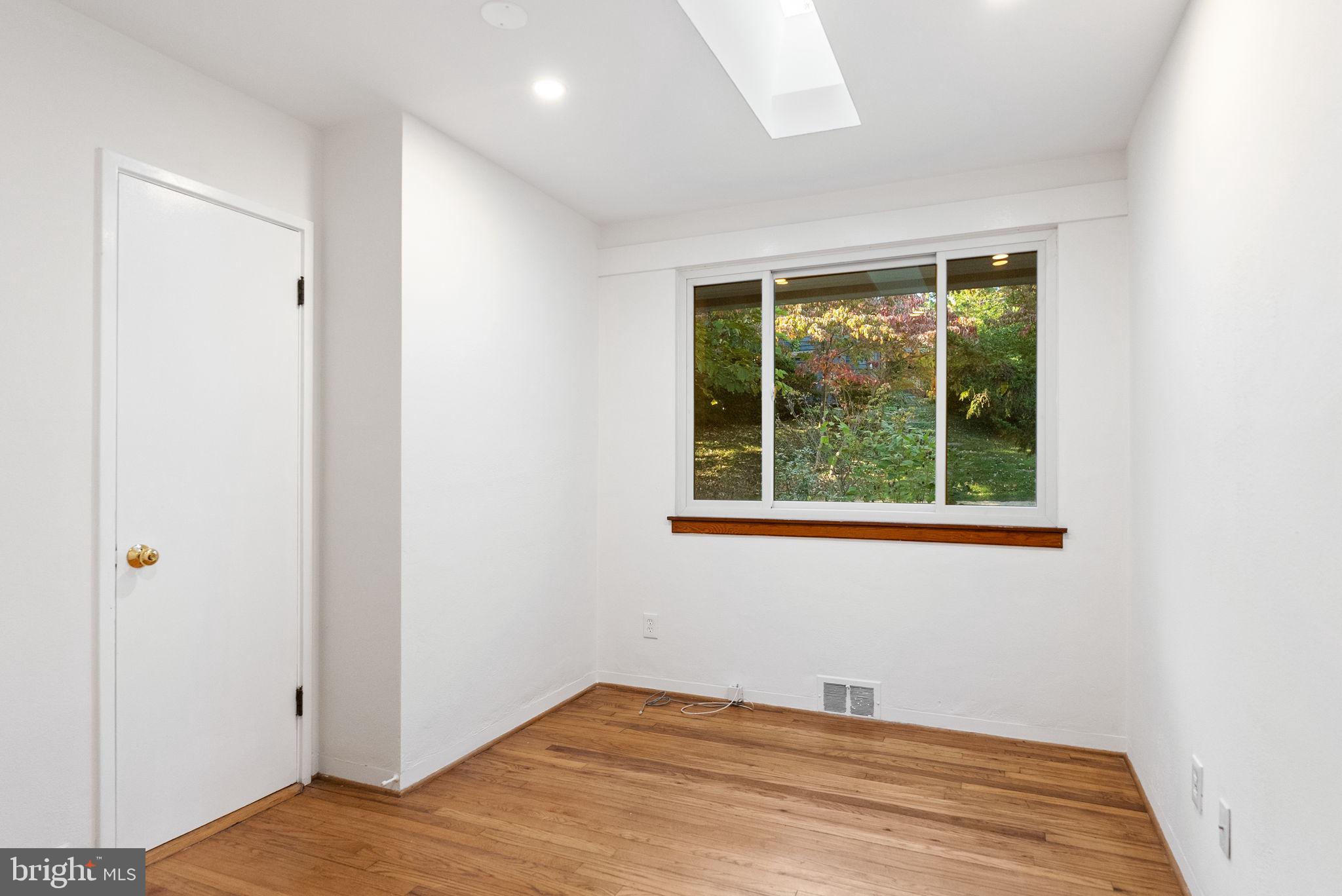 7111 Braeburn Place Bethesda, MD 20817 - Photo 40 of 86 a view of a bedroom with wooden floor and a window