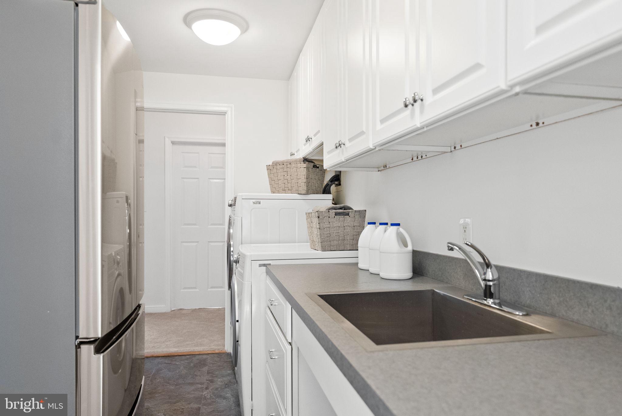 7111 Braeburn Place Bethesda, MD 20817 - Photo 43 of 86 a kitchen with a sink and a refrigerator