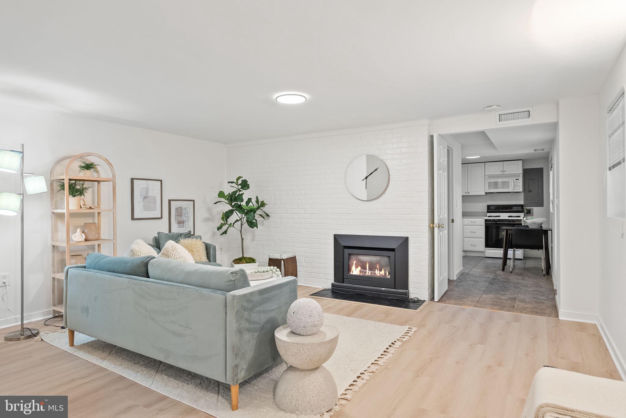 7111 Braeburn Place Bethesda, MD 20817 - Photo 47 of 86 a living room with furniture and a fireplace