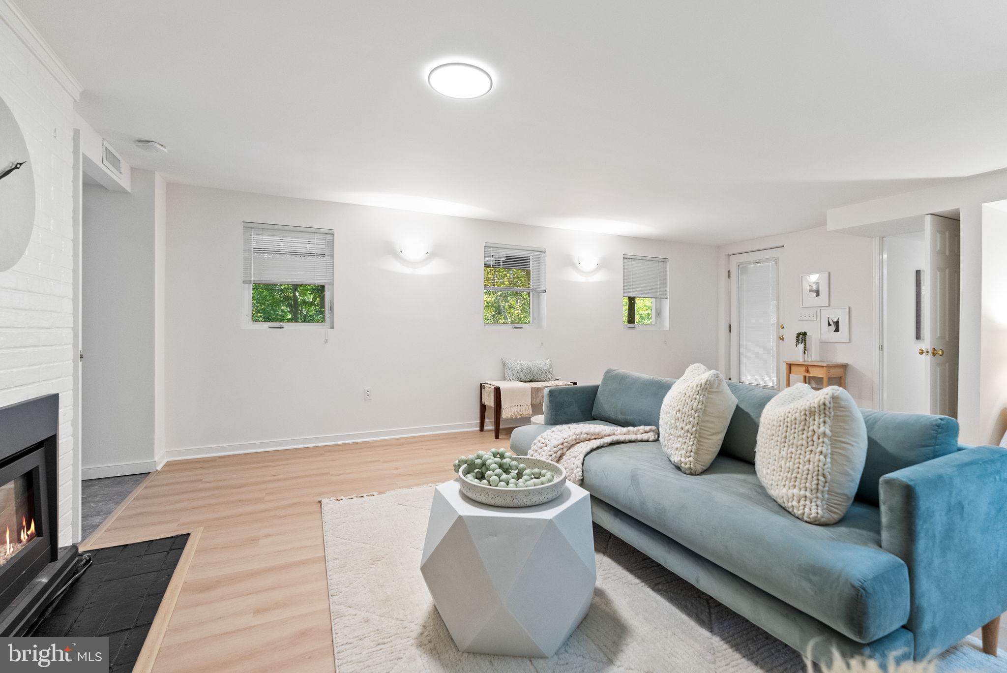 7111 Braeburn Place Bethesda, MD 20817 - Photo 49 of 86 a living room with furniture and a fireplace