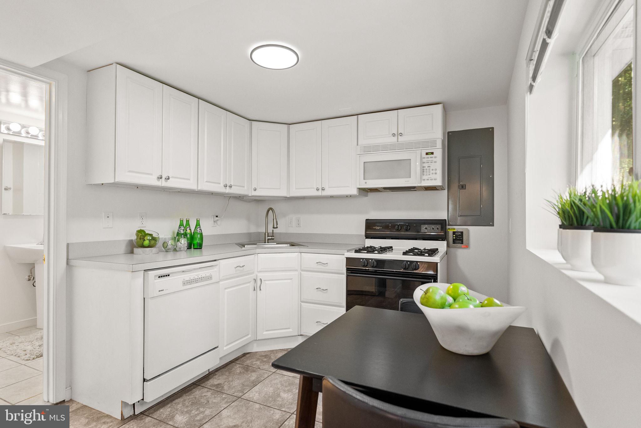 7111 Braeburn Place Bethesda, MD 20817 - Photo 51 of 86 a kitchen with a white cabinets and white appliances