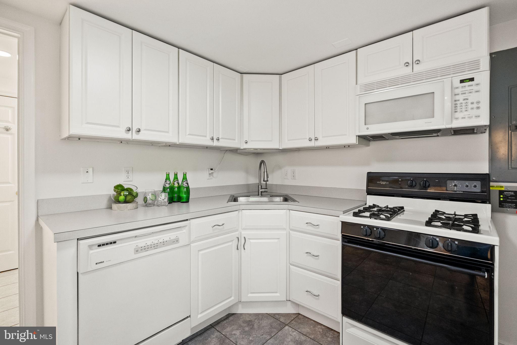 7111 Braeburn Place Bethesda, MD 20817 - Photo 52 of 86 a kitchen with white cabinets and white appliances