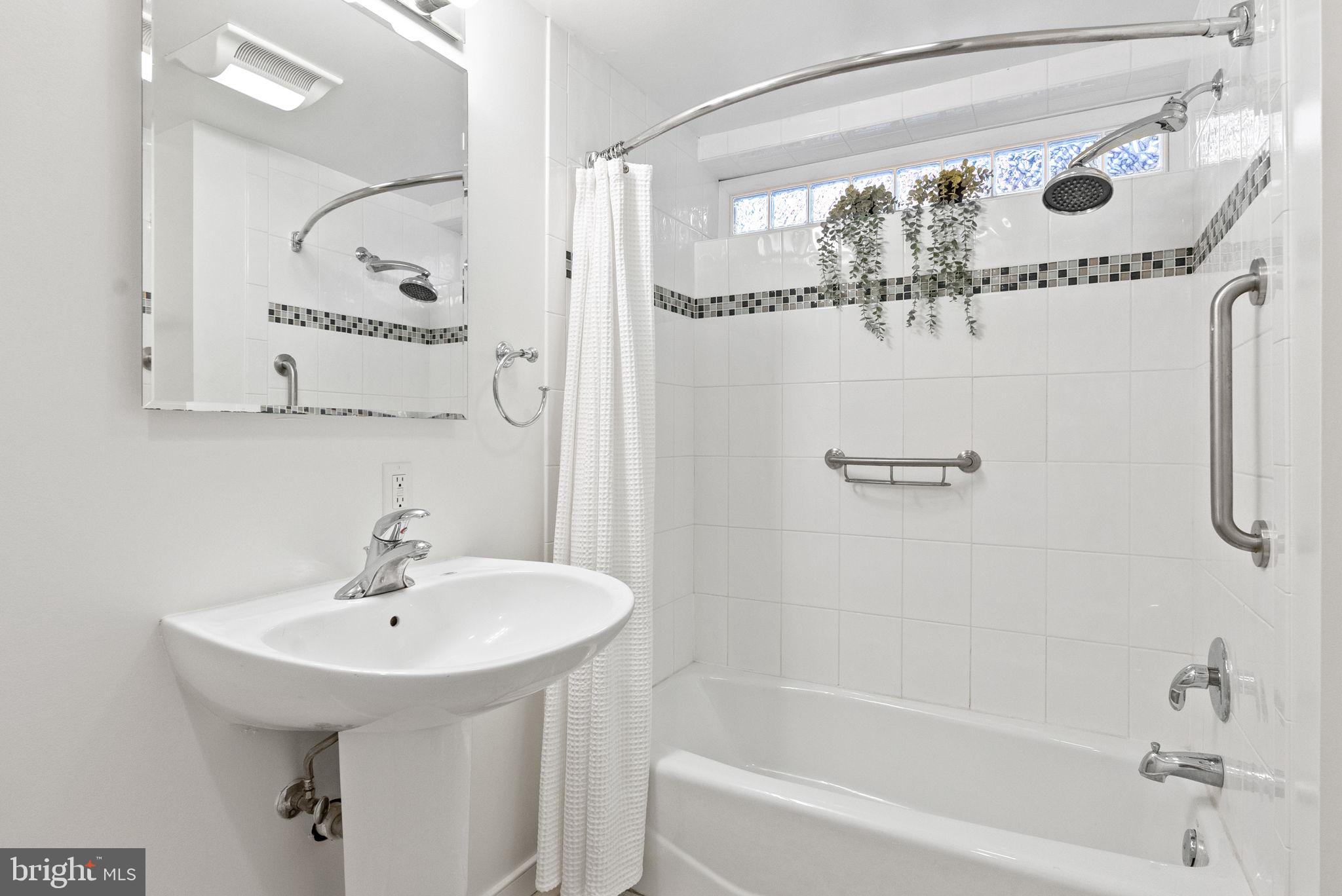 7111 Braeburn Place Bethesda, MD 20817 - Photo 55 of 86 a bathroom with a sink mirror toilet and bathtub