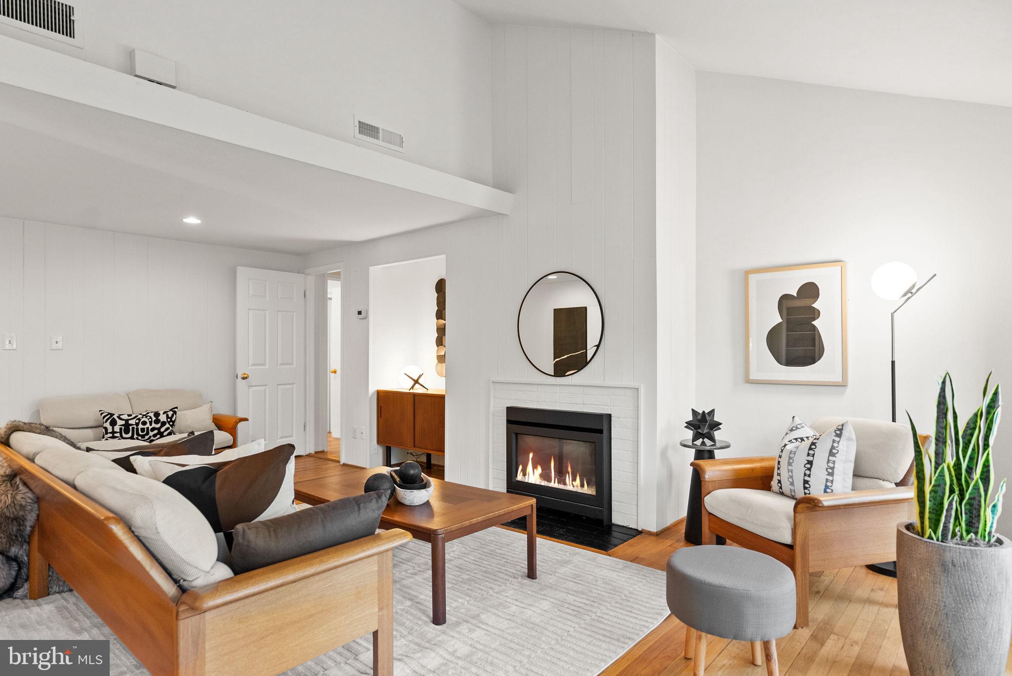 7111 Braeburn Place Bethesda, MD 20817 - Photo 9 of 86 a living room with furniture and a fireplace