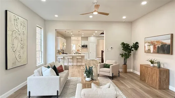 a living room with furniture a large window and a fireplace