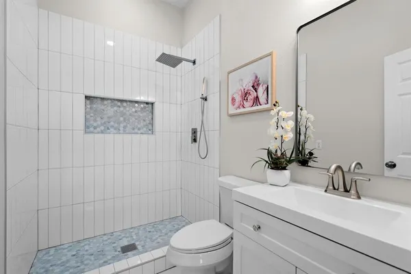a bathroom with a double vanity sink and a mirror