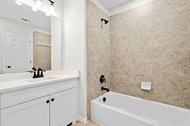 a bathroom with a sink a toilet and bathtub