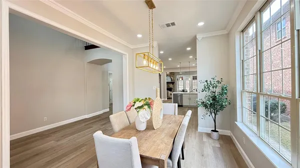 a dining room with furniture and wooden floor
